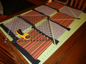 Make 'banners' with alternative fabrics.  The squares are sewn together with wavy black strips in between.